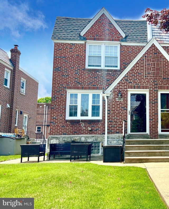 1838 Benson St, Philadelphia, PA 19152 - rear view of property featuring brick siding, a lawn, and entry steps