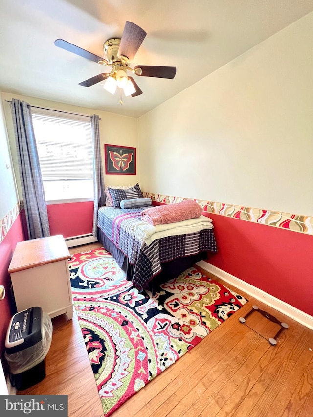 1838 Benson St, Philadelphia, PA 19152 - bedroom with baseboard heating, wood finished floors, and a ceiling fan