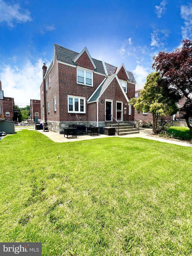 1838 Benson St, Philadelphia, PA 19152 - view of front facade with a front lawn, a patio area, a chimney, and brick siding