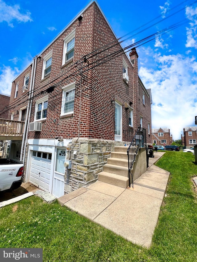 1838 Benson St, Philadelphia, PA 19152 - view of side of home with brick siding, a garage, and a lawn
