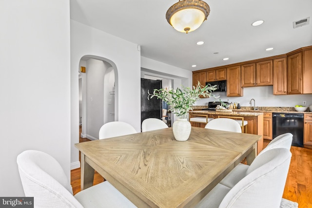 1928 Shepherd St NE, Washington, DC 20018 - dining room with arched walkways, light wood-style flooring, and recessed lighting