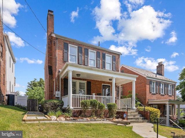 1928 Shepherd St NE, Washington, DC 20018 - view of front facade with a porch, brick siding, a chimney, and a front lawn
