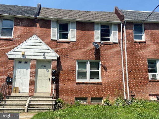 2133 Seneca Rd, Wilmington, DE 19805 - townhome / multi-family property featuring brick siding, roof with shingles, and cooling unit