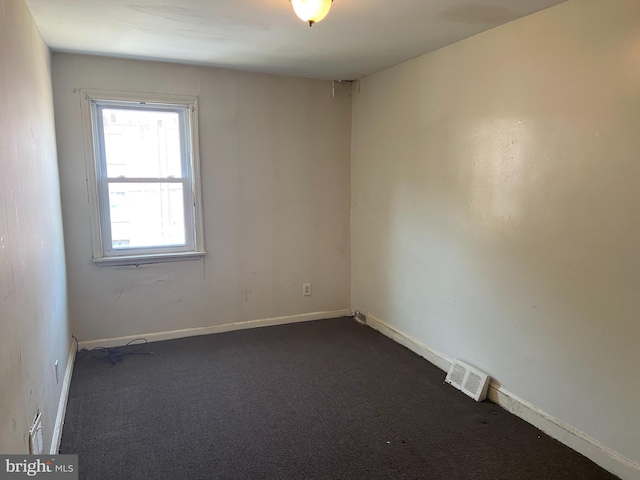 2133 Seneca Rd, Wilmington, DE 19805 - spare room featuring dark colored carpet and baseboards