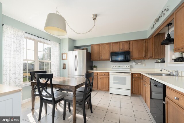 219 Flint Hill Rd, Alburtis, PA 18011 - kitchen with black appliances, brown cabinets, light countertops, and light tile patterned floors