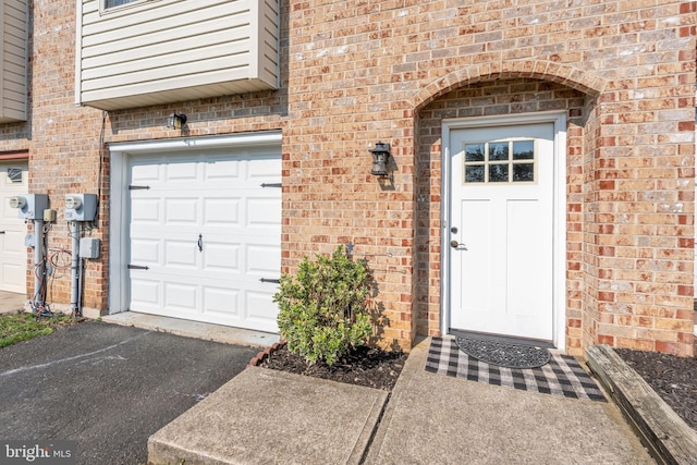 219 Flint Hill Rd, Alburtis, PA 18011 - property entrance featuring brick siding, a garage, and asphalt driveway