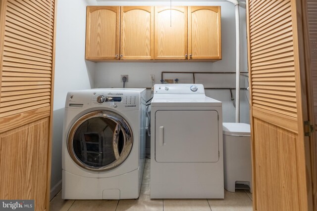 219 Flint Hill Rd, Alburtis, PA 18011 - laundry area featuring washing machine and clothes dryer, cabinet space, and light tile patterned flooring