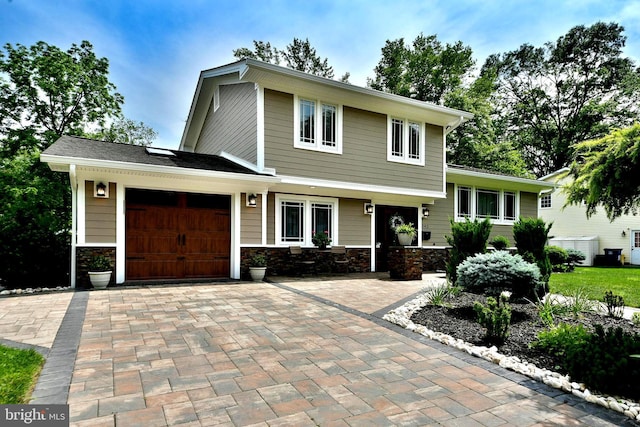 342 Glenn Ave, Lawrenceville, NJ 08648 - split level home with an attached garage, decorative driveway, and stone siding