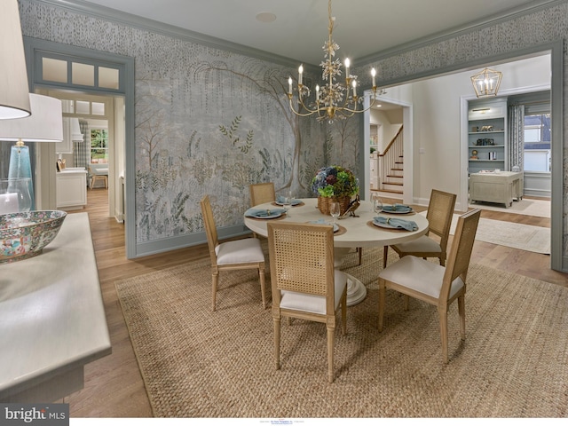 204 Walnut Tree Ln, Malvern, PA 19355 - dining area featuring wallpapered walls, wood finished floors, a chandelier, stairs, and ornamental molding