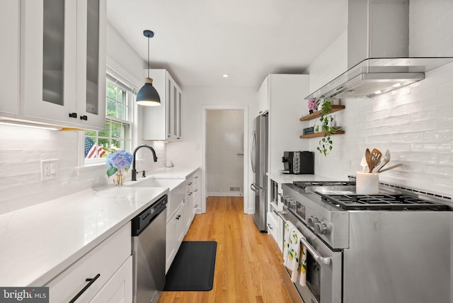 6018 25th Rd N, Arlington, VA 22207 - kitchen featuring wall chimney range hood, appliances with stainless steel finishes, white cabinetry, glass insert cabinets, and recessed lighting