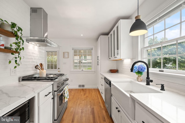 6018 25th Rd N, Arlington, VA 22207 - kitchen featuring stainless steel appliances, wall chimney exhaust hood, decorative backsplash, white cabinetry, and open shelves