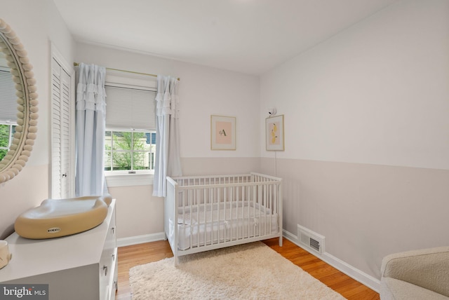 6018 25th Rd N, Arlington, VA 22207 - bedroom with wood finished floors and a crib