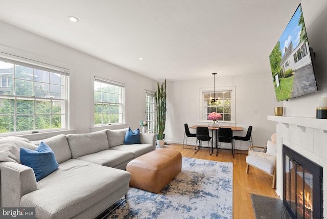 6018 25th Rd N, Arlington, VA 22207 - living room featuring wood finished floors, a fireplace with flush hearth, recessed lighting, and a chandelier