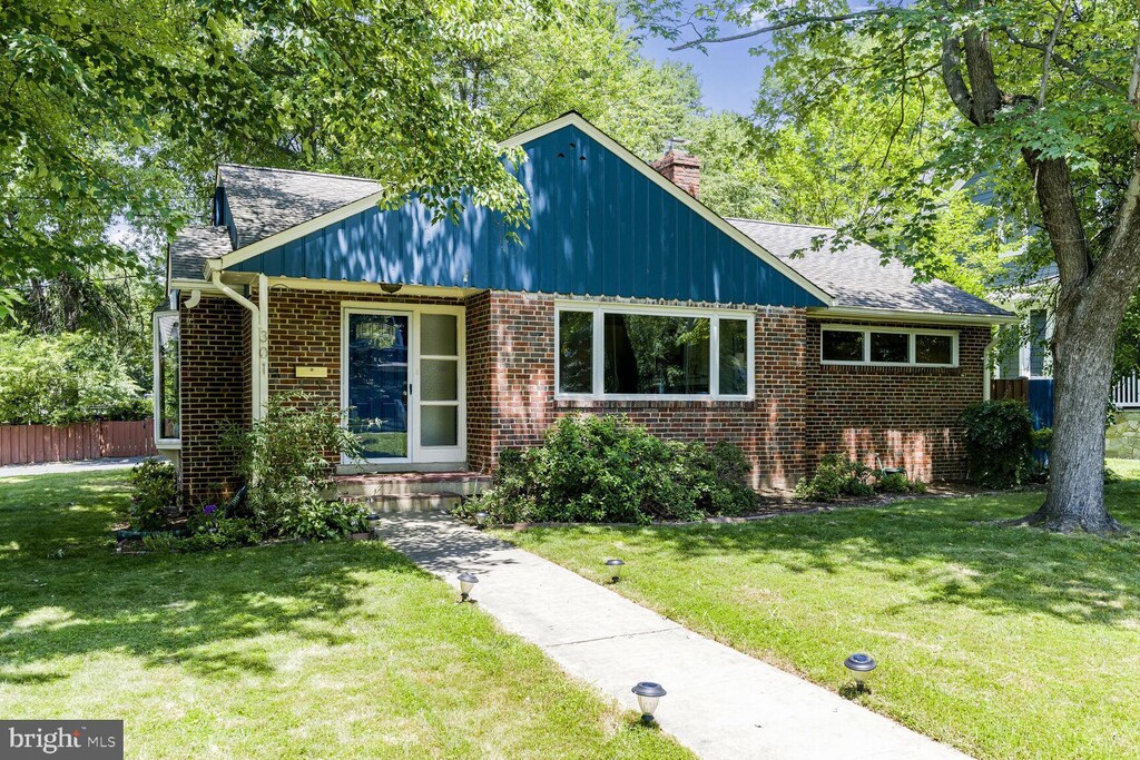 301 Pine St, Falls Church, VA 22046 - view of front of home featuring brick siding and a chimney
