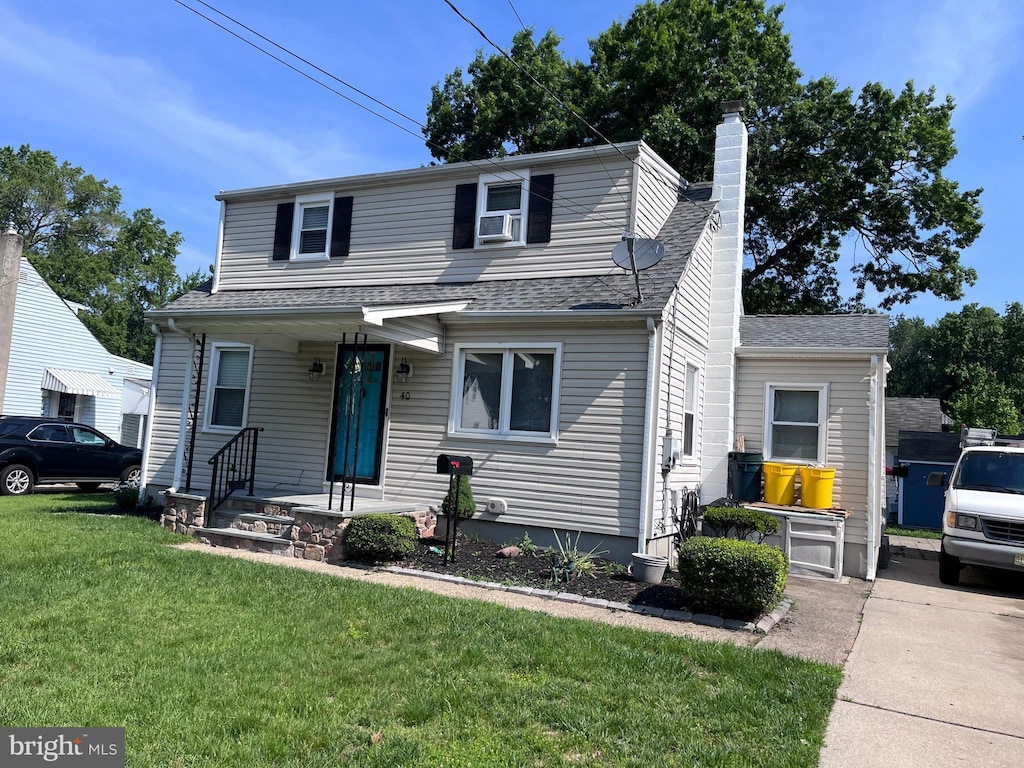 40 Fogarty Dr, Hamilton, NJ 08619 - view of front of home with a front lawn, a chimney, and a shingled roof