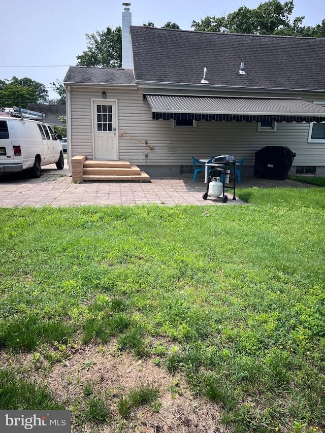 40 Fogarty Dr, Hamilton, NJ 08619 - back of house featuring a yard, a shingled roof, and a chimney