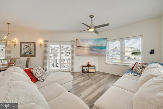 209 N New York Ave Unit 2, North Wildwood, NJ 08260 - living room with a ceiling fan, wood finished floors, and a chandelier