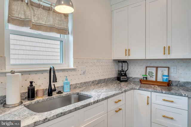 209 N New York Ave Unit 2, North Wildwood, NJ 08260 - kitchen featuring white cabinetry, backsplash, and light stone countertops