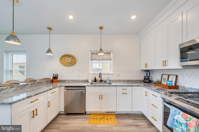 209 N New York Ave Unit 2, North Wildwood, NJ 08260 - kitchen with stainless steel appliances, white cabinets, backsplash, a peninsula, and light wood-type flooring