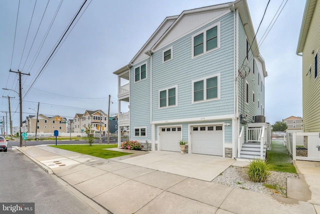 209 N New York Ave Unit 2, North Wildwood, NJ 08260 - back of house featuring a garage, driveway, and stone siding