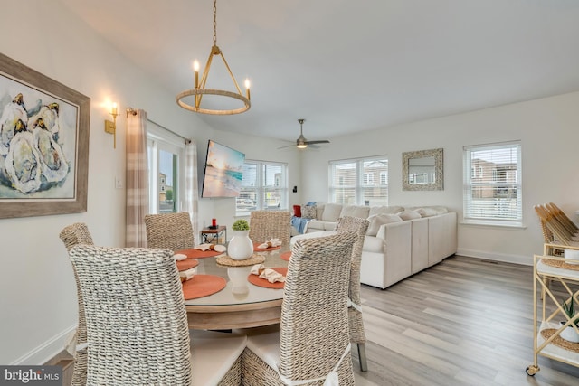 209 N New York Ave Unit 2, North Wildwood, NJ 08260 - dining space with a chandelier, light wood-type flooring, and a ceiling fan
