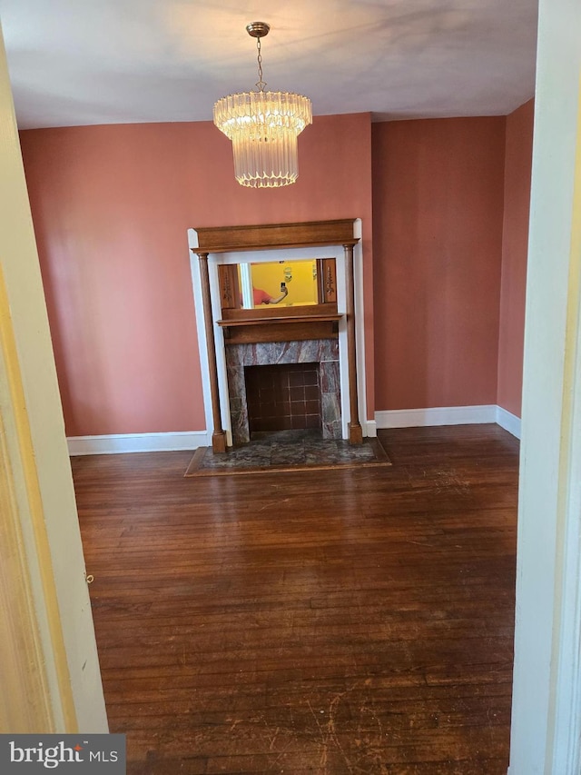 732 NW Morton St NW, Washington, DC 20010 - unfurnished living room featuring wood-type flooring, a chandelier, and a fireplace