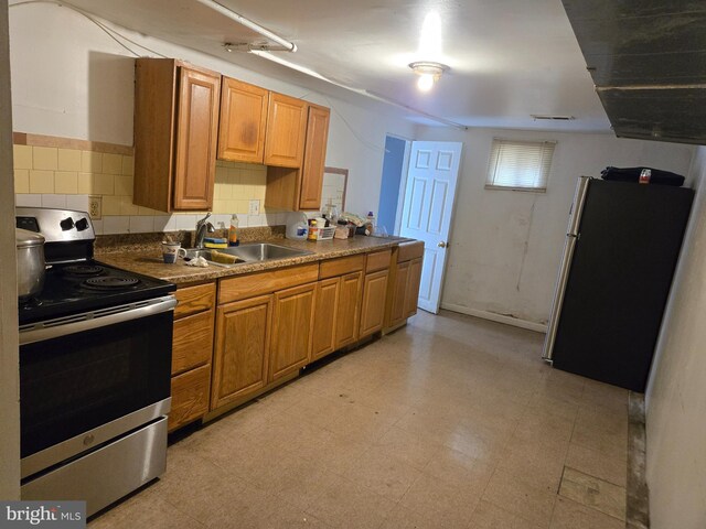 732 NW Morton St NW, Washington, DC 20010 - kitchen featuring appliances with stainless steel finishes, light flooring, and brown cabinetry