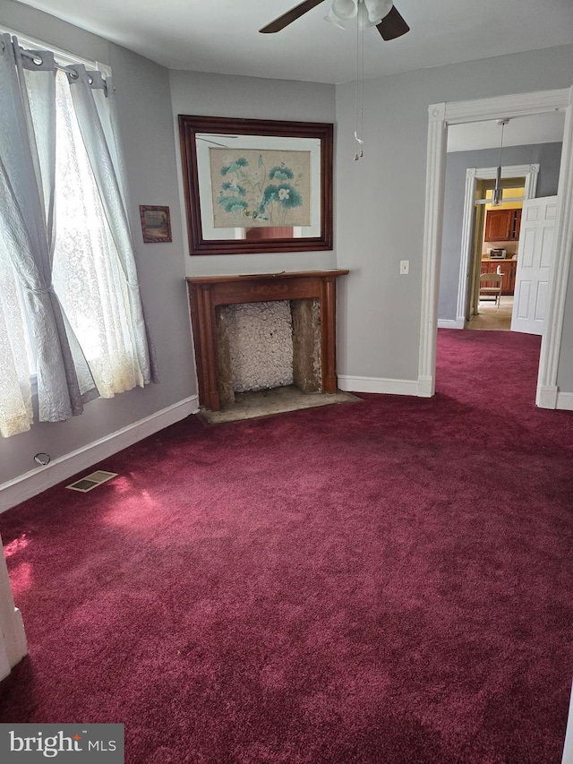732 NW Morton St NW, Washington, DC 20010 - unfurnished living room featuring carpet flooring, a ceiling fan, and a fireplace with flush hearth