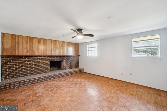 6 Flower Hill Ct, Gaithersburg, MD 20879 - unfurnished living room with wood walls, a ceiling fan, and a brick fireplace