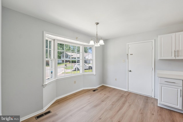 6 Flower Hill Ct, Gaithersburg, MD 20879 - unfurnished dining area featuring light wood-type flooring and a chandelier