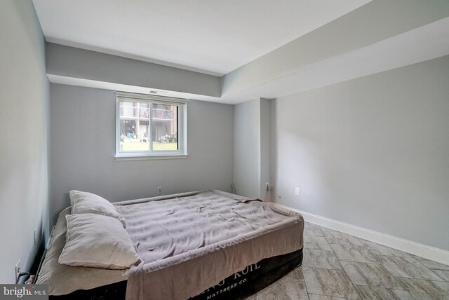9730 Kingsbridge Dr Unit 002, Fairfax, VA 22031 - bedroom with baseboards and light marble finish flooring