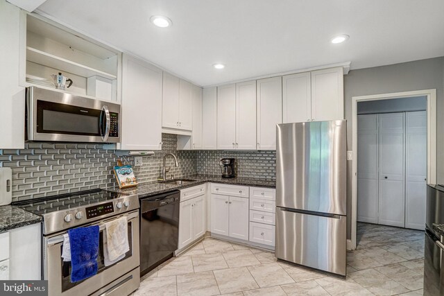 9730 Kingsbridge Dr Unit 002, Fairfax, VA 22031 - kitchen featuring stainless steel appliances, dark stone countertops, white cabinetry, tasteful backsplash, and recessed lighting
