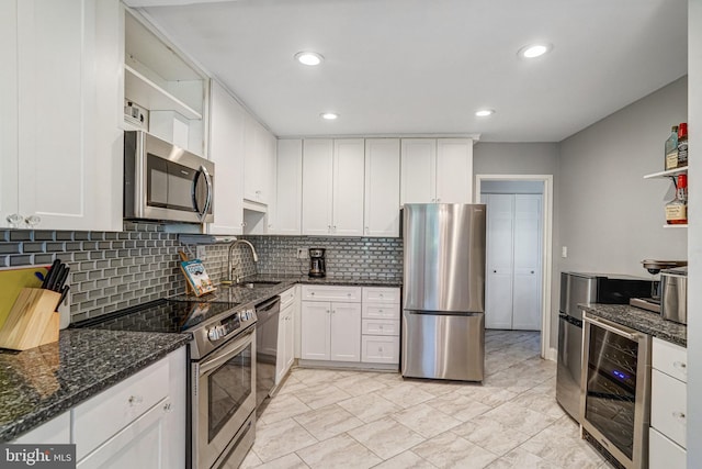9730 Kingsbridge Dr Unit 002, Fairfax, VA 22031 - kitchen with appliances with stainless steel finishes, wine cooler, white cabinets, tasteful backsplash, and dark stone counters