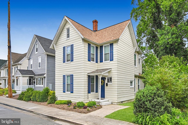 322 W End Ave, Cambridge, MD 21613 - view of front facade featuring a chimney and roof with shingles