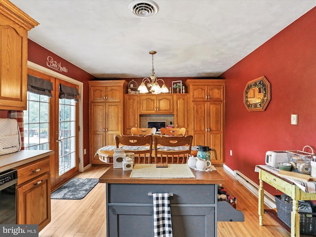 15606 Winslow St SW, Cresaptown, MD 21502 - kitchen with a chandelier, light wood finished floors, a fireplace, black dishwasher, and baseboard heating