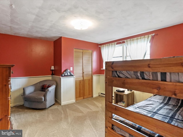 15606 Winslow St SW, Cresaptown, MD 21502 - bedroom featuring a closet, wainscoting, carpet flooring, a baseboard radiator, and wooden walls
