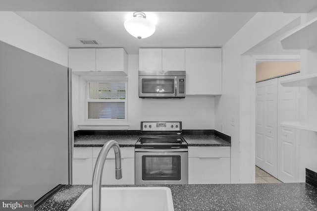 11920 Roan Ln, North Potomac, MD 20878 - kitchen featuring appliances with stainless steel finishes, white cabinets, and dark countertops