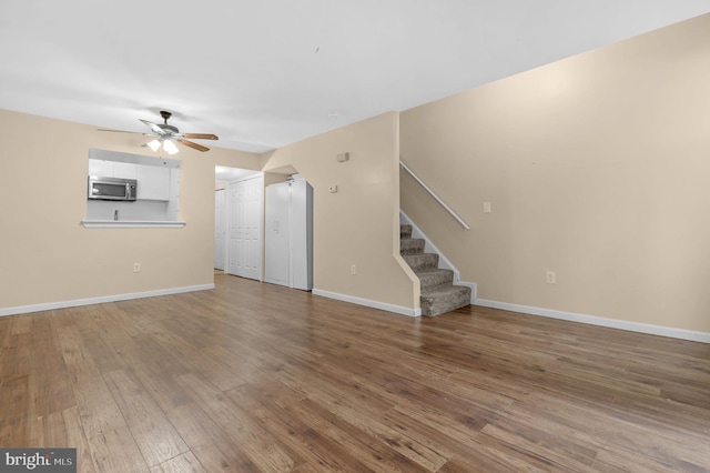 11920 Roan Ln, North Potomac, MD 20878 - unfurnished living room with a ceiling fan, stairway, and hardwood / wood-style flooring