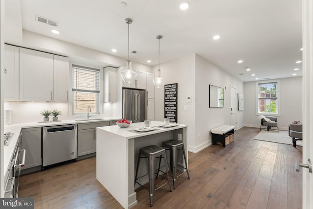 417 4th St SE Unit 2, Washington, DC 20003 - kitchen featuring appliances with stainless steel finishes, recessed lighting, dark wood-style flooring, a kitchen island, and a breakfast bar