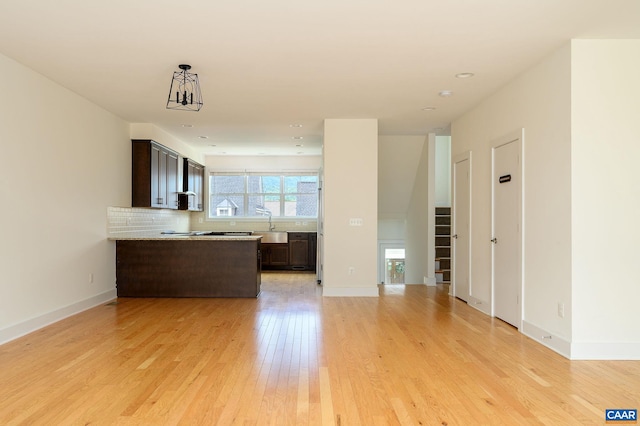 407 Fennel Rd, Crozet, VA 22932 - kitchen with dark brown cabinets, open floor plan, light wood finished floors, and a peninsula