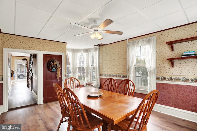 123 N 2nd St, Newport, PA 17074 - dining area with wallpapered walls, wood finished floors, ceiling fan, and ornamental molding
