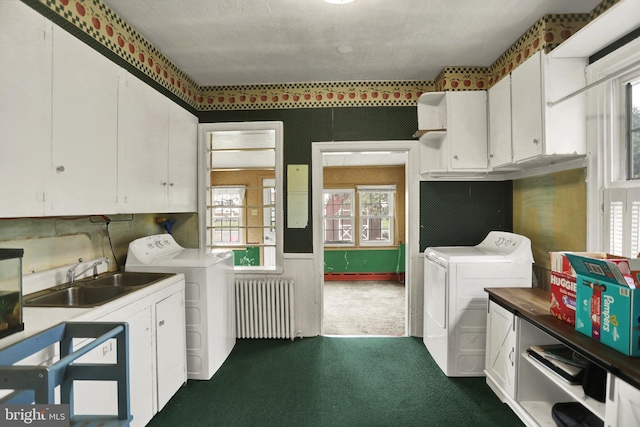 123 N 2nd St, Newport, PA 17074 - laundry room featuring radiator heating unit, washing machine and dryer, dark colored carpet, and cabinet space