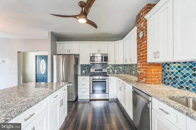 211 Penn St, Ridley Park, PA 19078 - kitchen featuring stainless steel appliances, a ceiling fan, dark wood-style floors, decorative backsplash, and light stone countertops