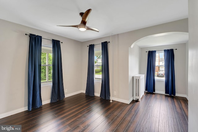 211 Penn St, Ridley Park, PA 19078 - spare room with arched walkways, dark wood-style flooring, and healthy amount of natural light
