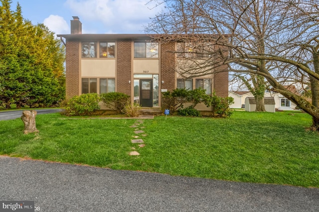 7617 Seven Mile Ln, Baltimore, MD 21208 - view of front of home with a front yard, a chimney, and brick siding