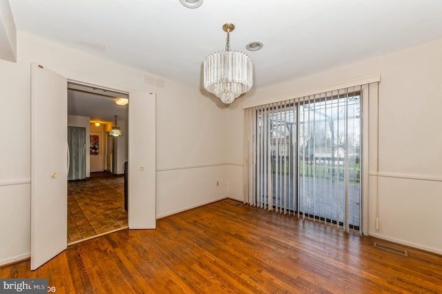 7617 Seven Mile Ln, Baltimore, MD 21208 - spare room with a chandelier and wood finished floors