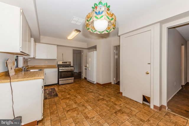7617 Seven Mile Ln, Baltimore, MD 21208 - kitchen featuring stainless steel gas range, white fridge with ice dispenser, light countertops, light stone finish flooring, and white cabinetry