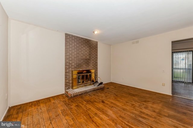 7617 Seven Mile Ln, Baltimore, MD 21208 - unfurnished living room featuring hardwood / wood-style floors and a fireplace
