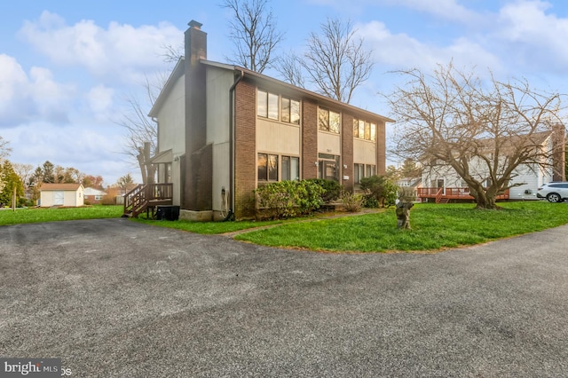 7617 Seven Mile Ln, Baltimore, MD 21208 - view of side of home with a chimney, a lawn, and driveway