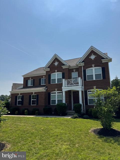 12701 Coventry Manor Way, Upper Marlboro, MD 20772 - colonial inspired home featuring brick siding, a front lawn, and a balcony